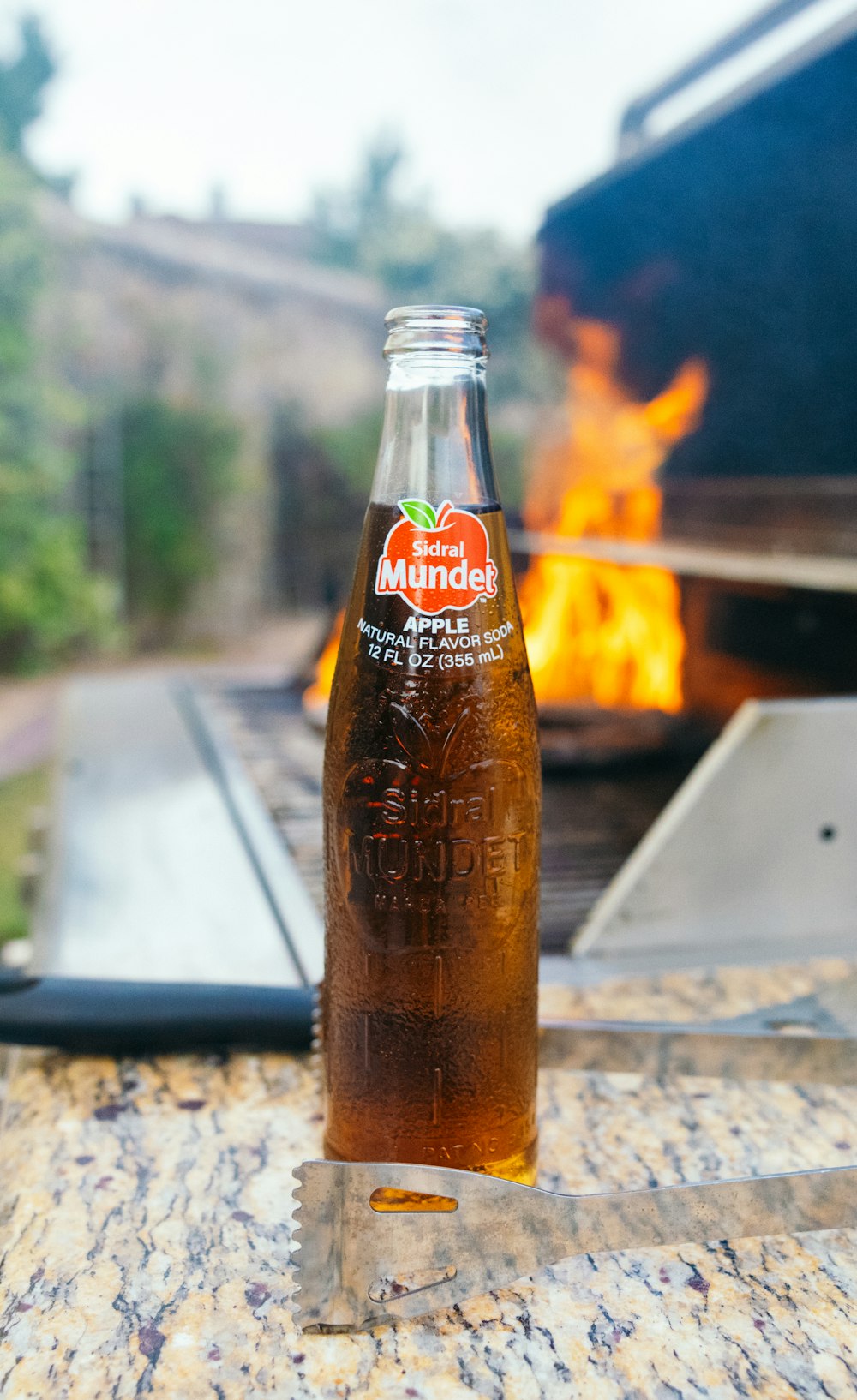 a bottle of beer sitting on top of a wooden table