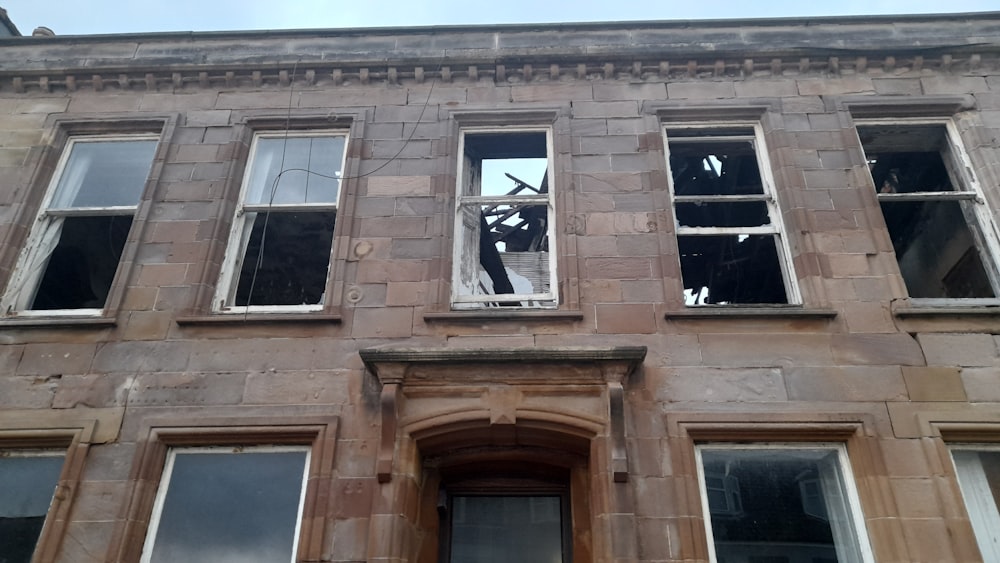 a building with broken windows and broken glass