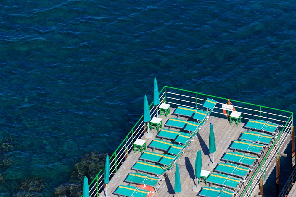 a pier with chairs and umbrellas on it