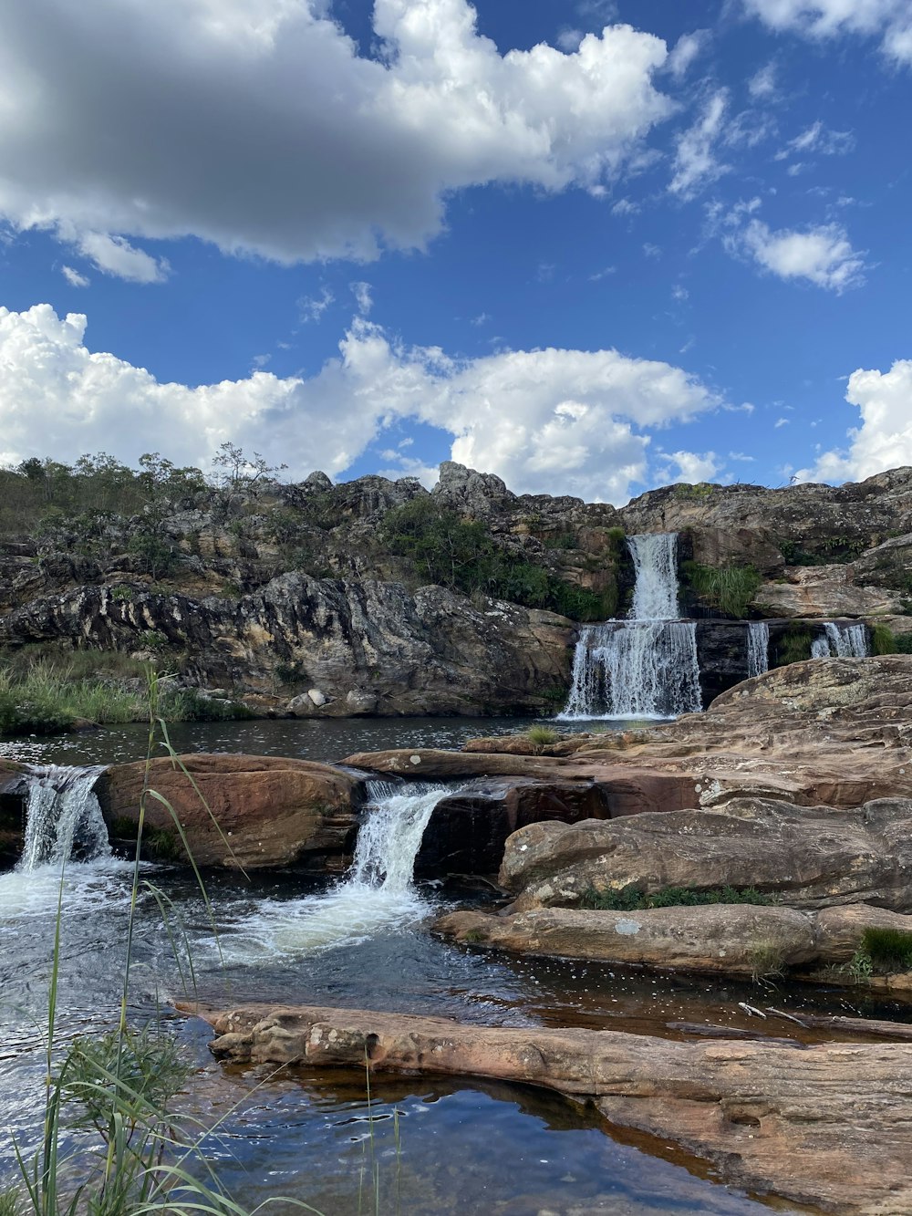 a small waterfall in the middle of a rocky area