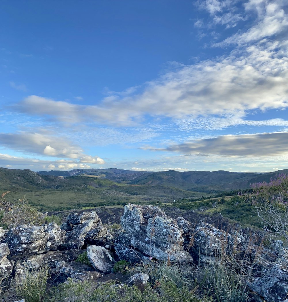 a bench sitting on top of a rocky hillside