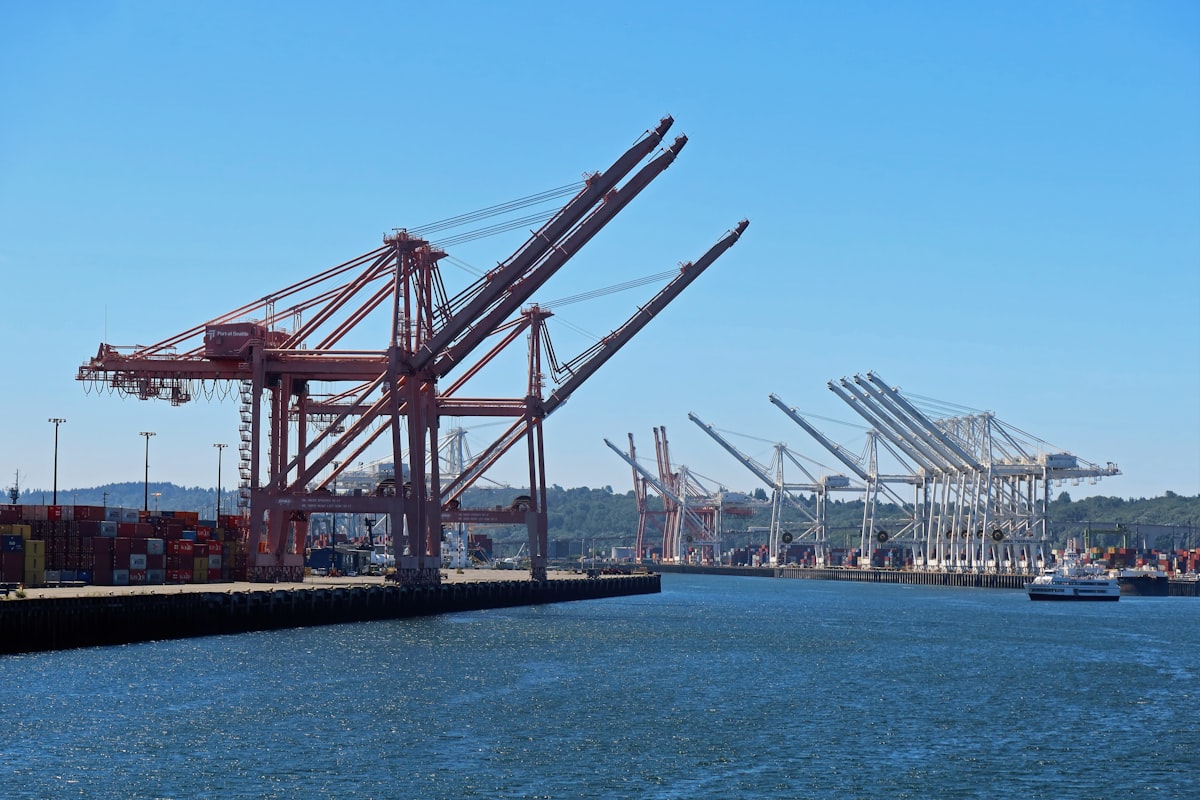 A shipping port with container cranes representing international trade and tariff collection