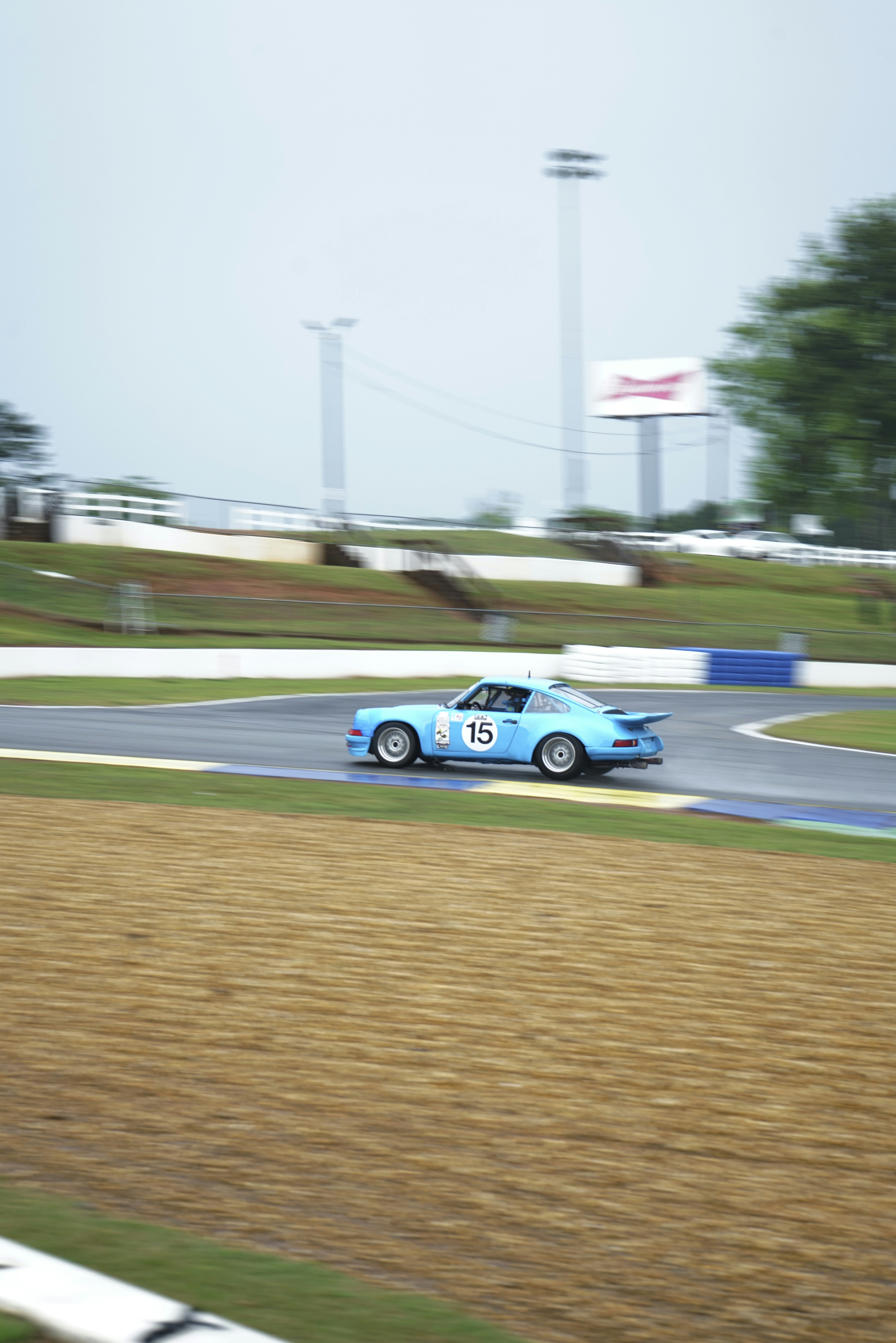 A blue race car driving down a race track photo – Free Porsche Image on ...