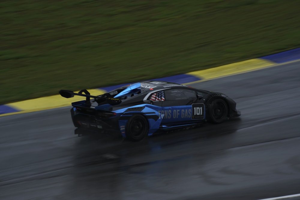 a race car driving down a wet track