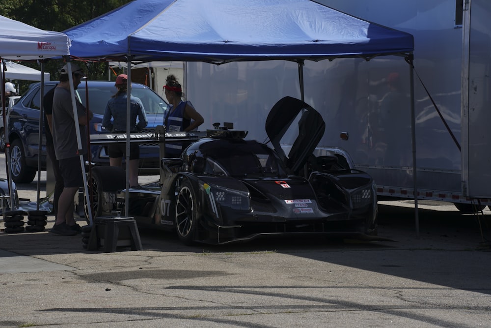 a race car is parked under a tent