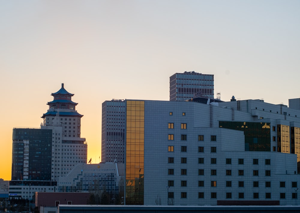 a city skyline with tall buildings and a clock tower