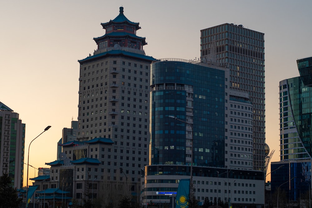 a city skyline with tall buildings and a clock tower