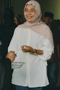 A smiling volunteer interacting with community members.