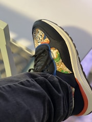 Close-up of a vibrant sneaker featuring intricate street art designs by Indian artists.