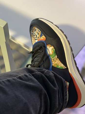 Close-up of a stylish purple gradient sneaker from summy fashion, set against a soft urban backdrop.