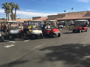 A row of electric golf carts lined up outside the Cornwall sales and repair shop.