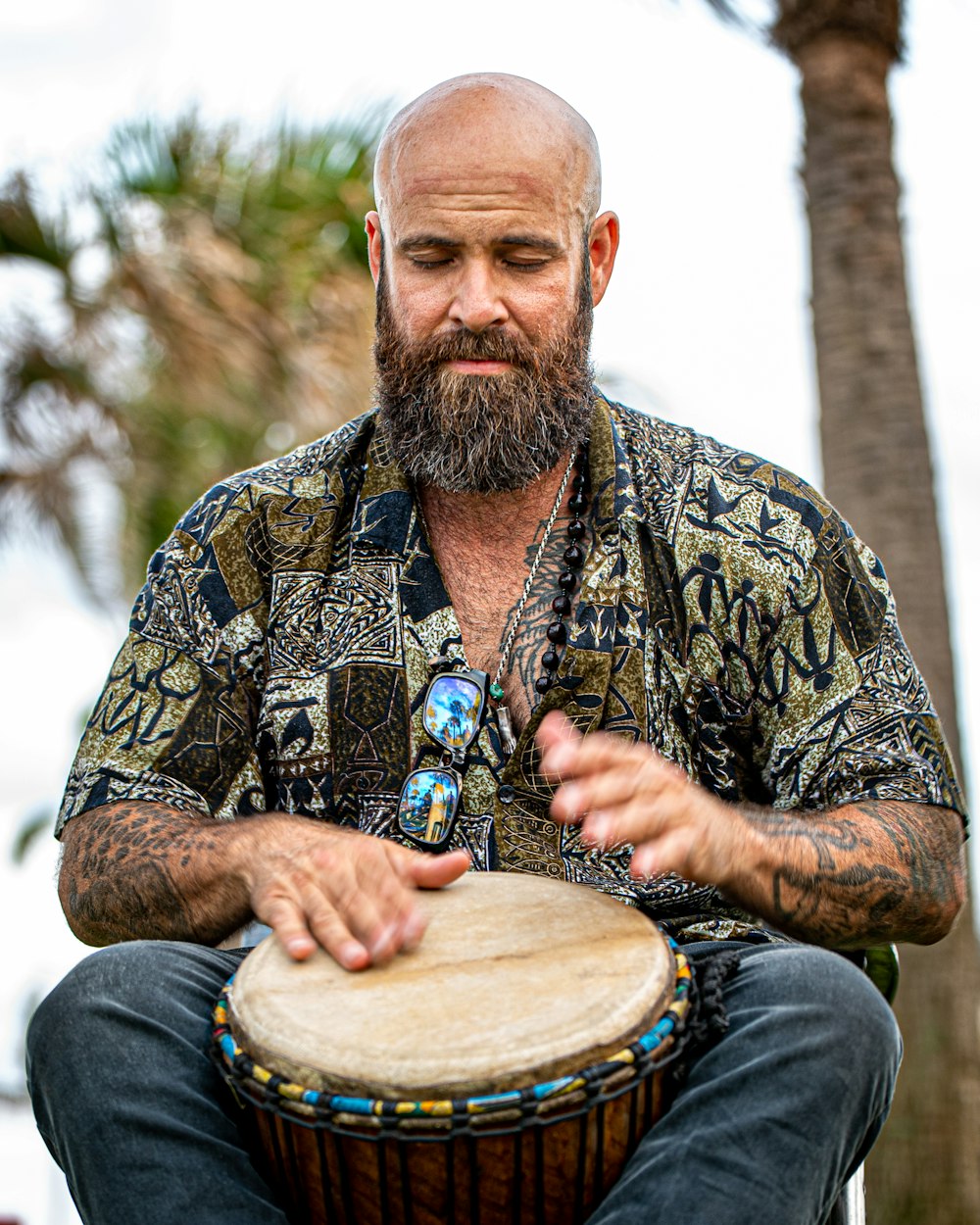 a man with a beard playing a drum