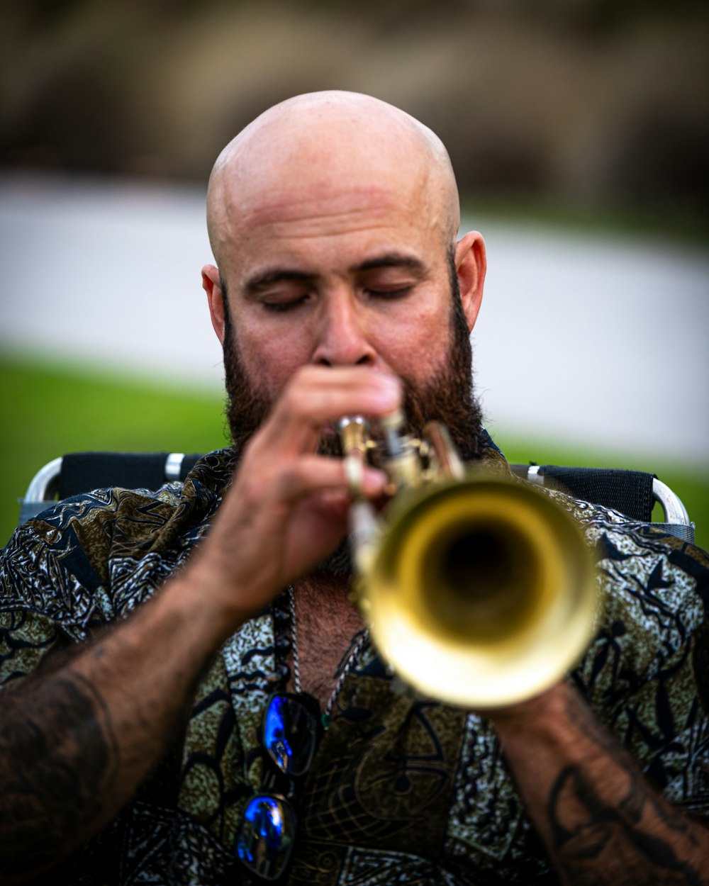 a man with a bald head playing a trumpet