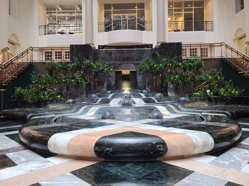 a lobby with a fountain in the middle of it