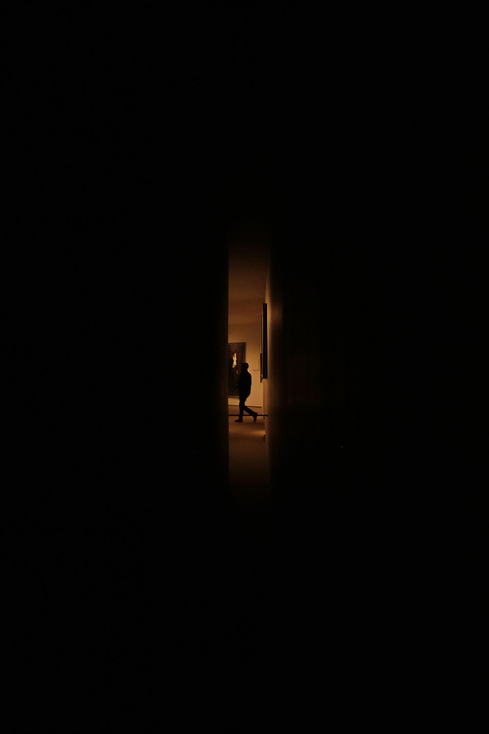 a person is walking out of a dark room