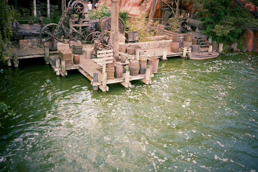 a group of old machinery sitting on top of a body of water