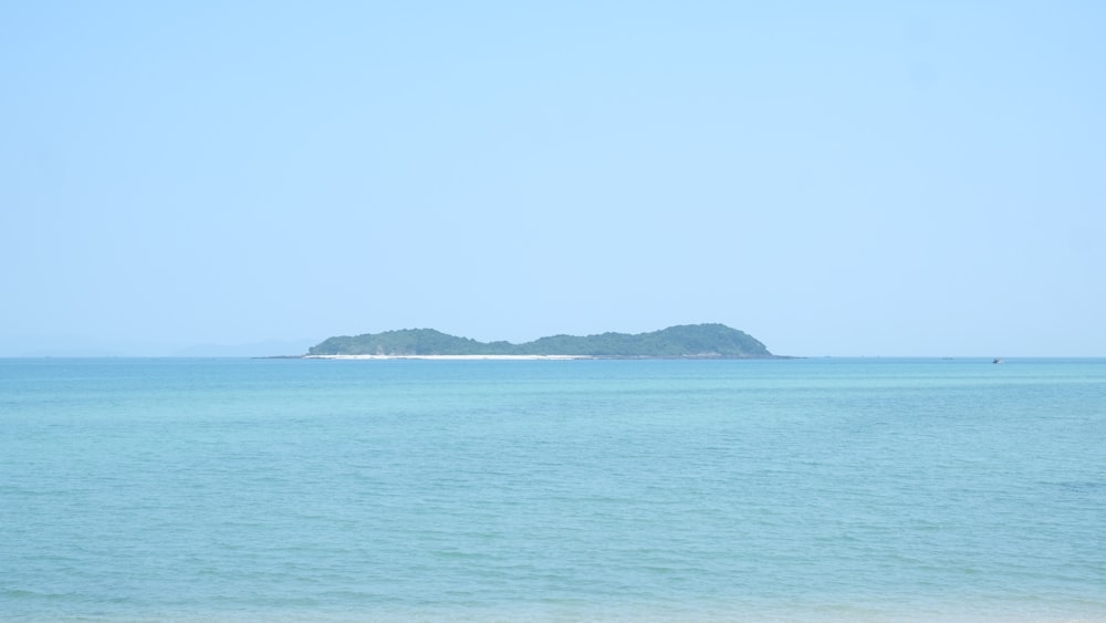 a body of water with a small island in the distance