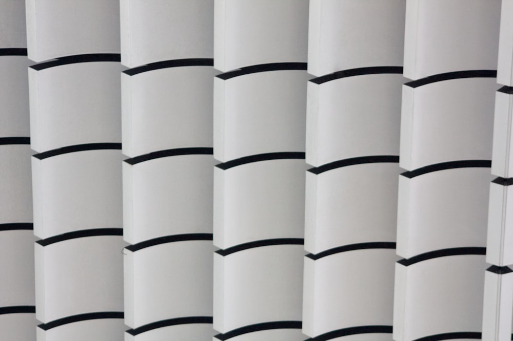 a close up of a white curtain with black stripes