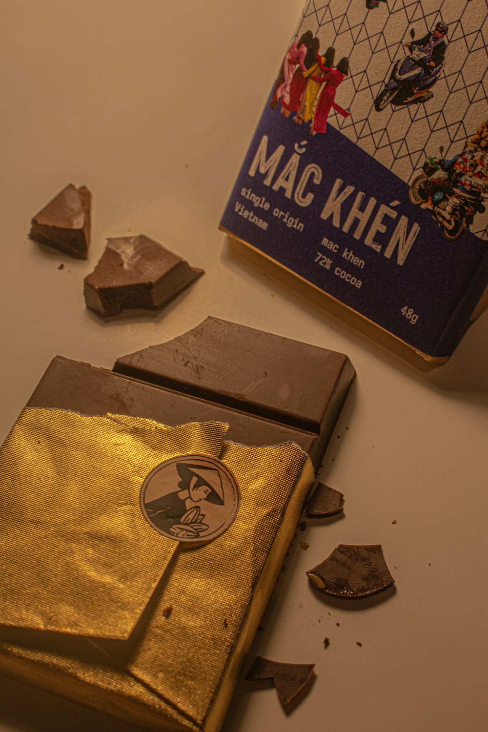 a book and some pieces of chocolate on a table