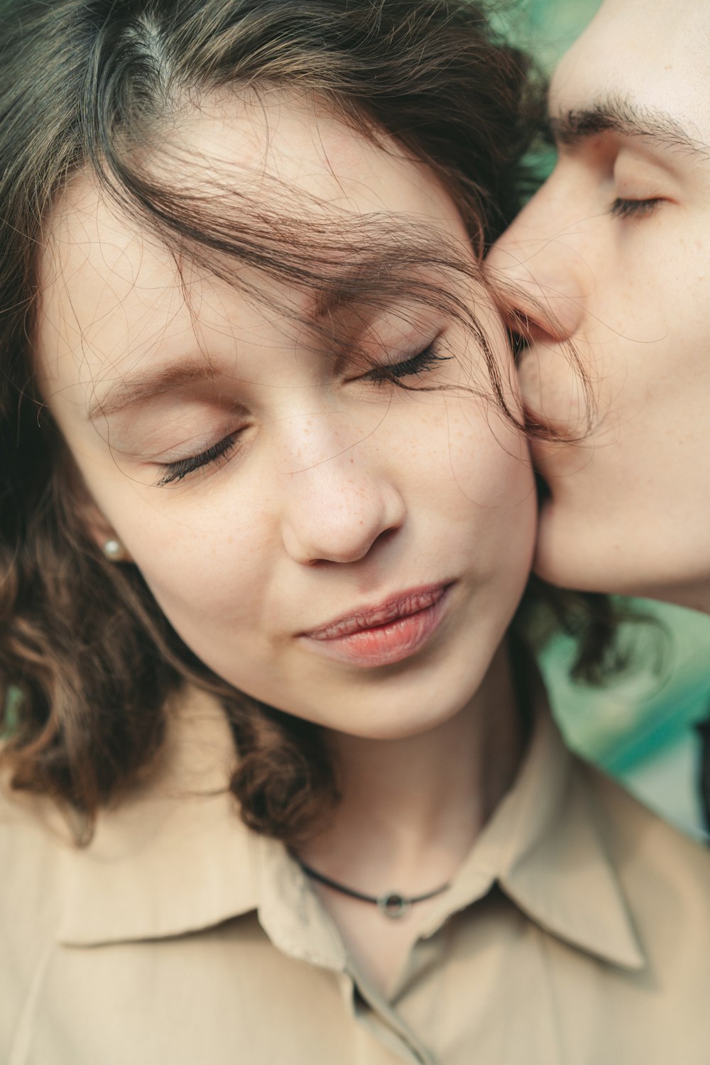 a man and a woman kissing each other