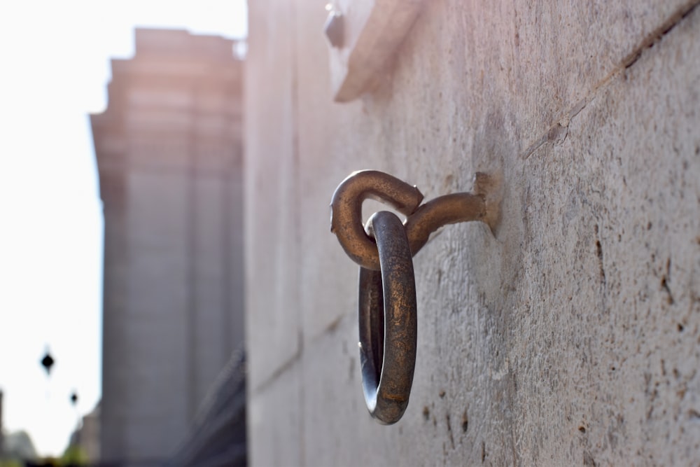a close up of a metal hook on a wall