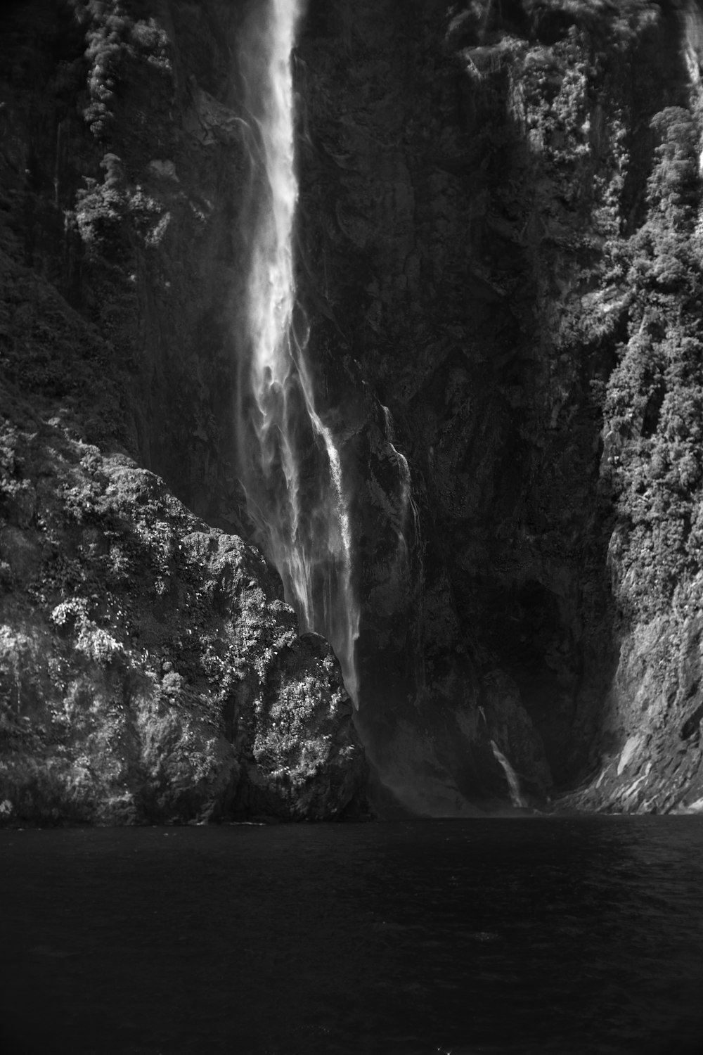 a black and white photo of a waterfall