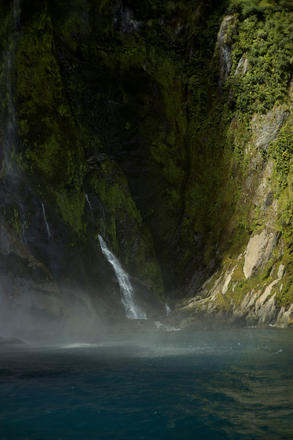 a waterfall with a waterfall cascading down the side of it