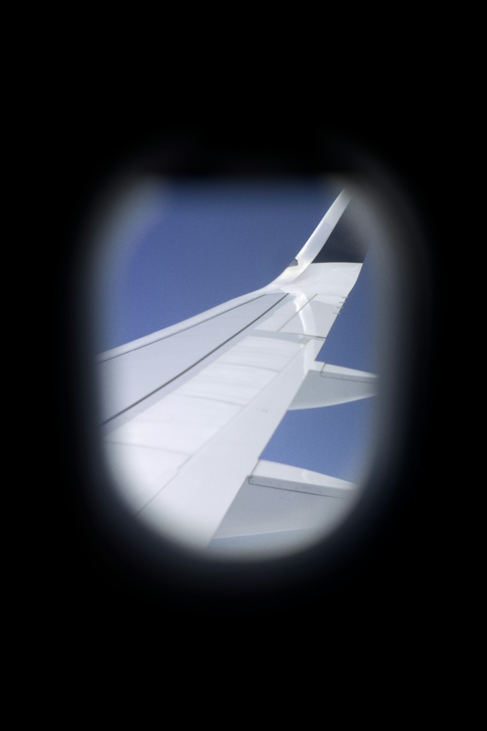 a view of the wing of a plane through a window