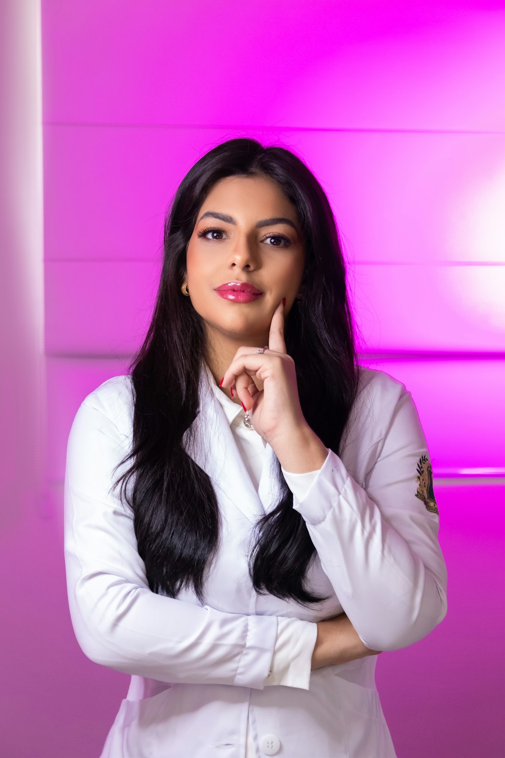 a woman in a white suit posing for a picture