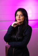 a woman standing in front of a purple wall