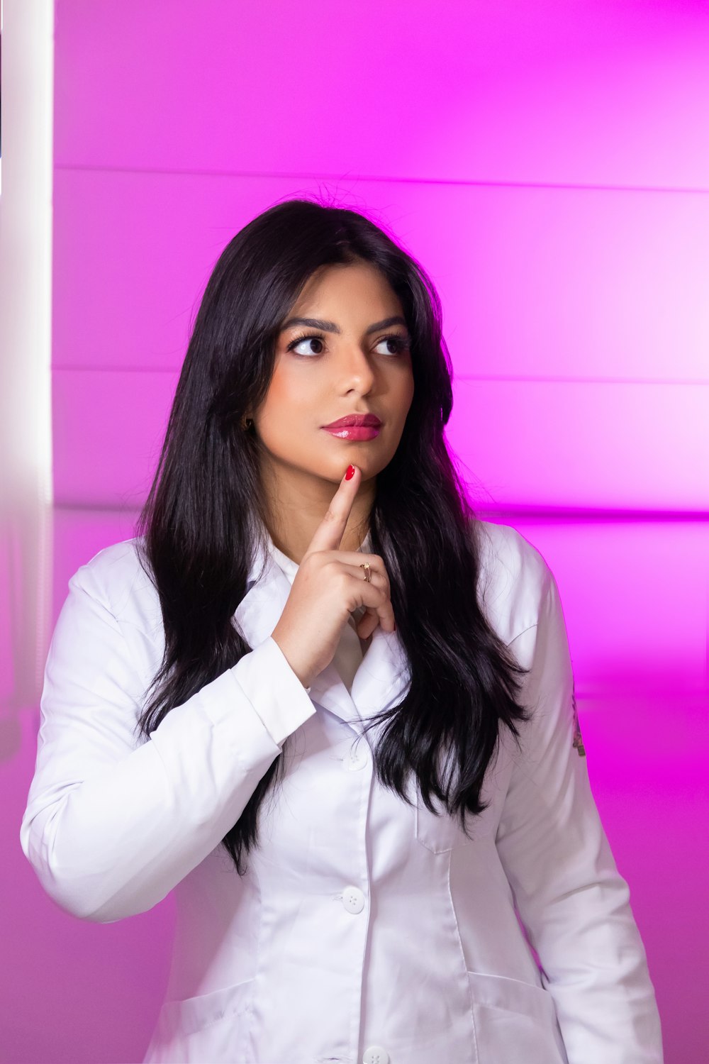 a woman in a lab coat is posing for a picture