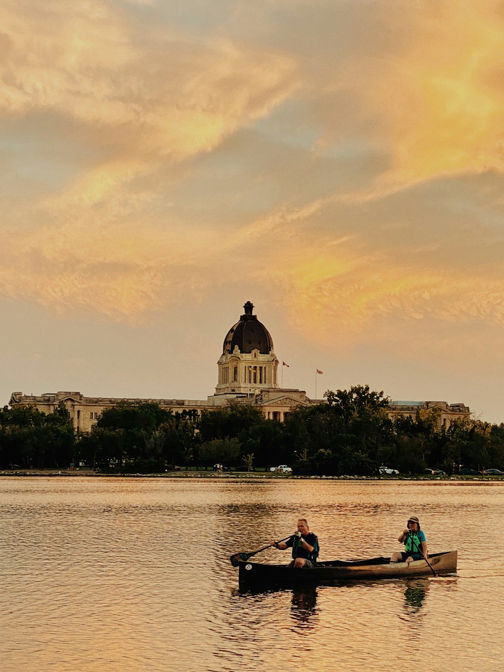 a couple of people in a canoe on a body of water