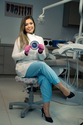 A smiling patient shaking hands with a dentist in a bright, modern Albanian dental clinic.