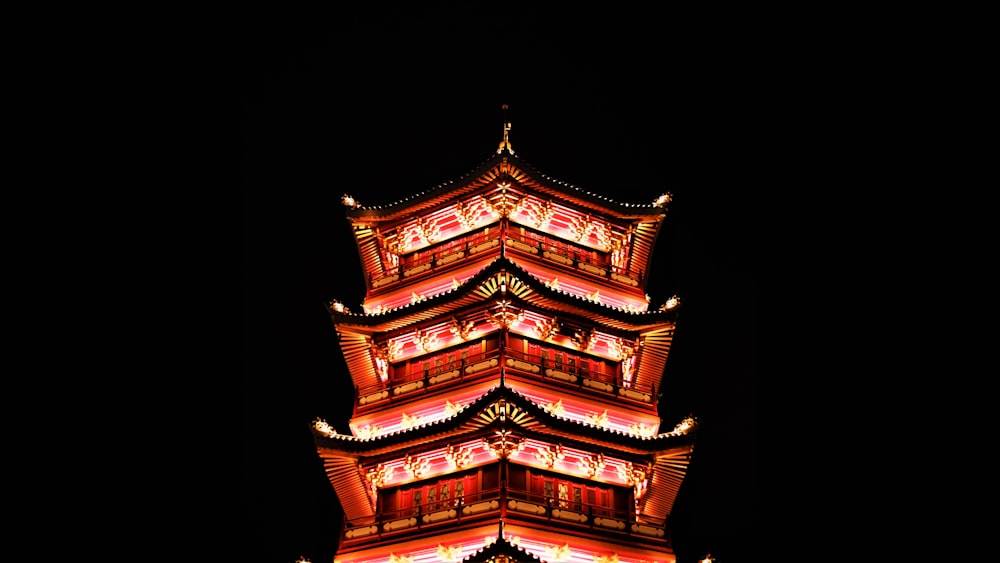 a tall tower lit up in the dark