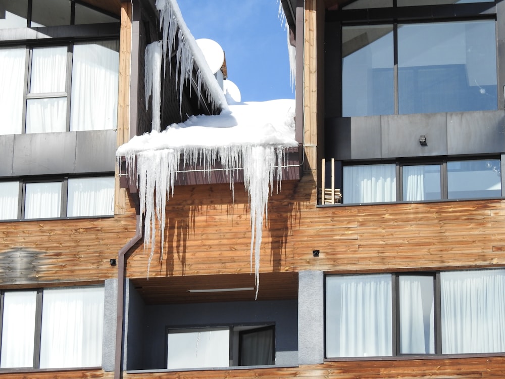 a building with icicles hanging off of it's windows