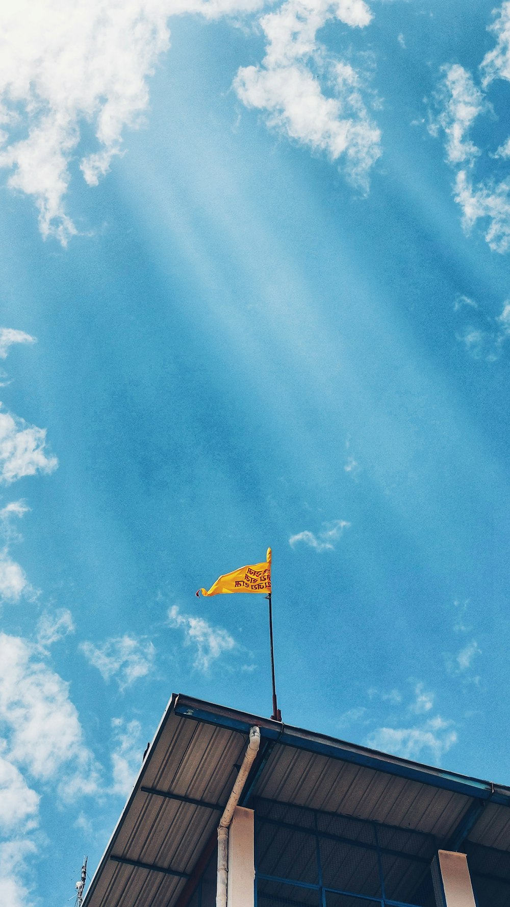 a yellow flag on top of a building
