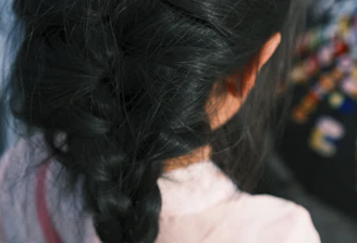 Close-up of beautifully braided African hair styles in vibrant colors.