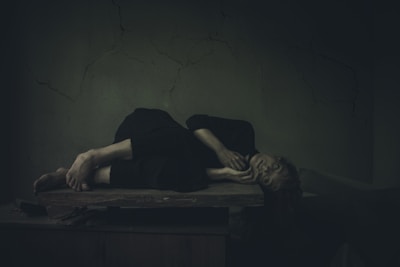 a woman laying on a table in a dark room
