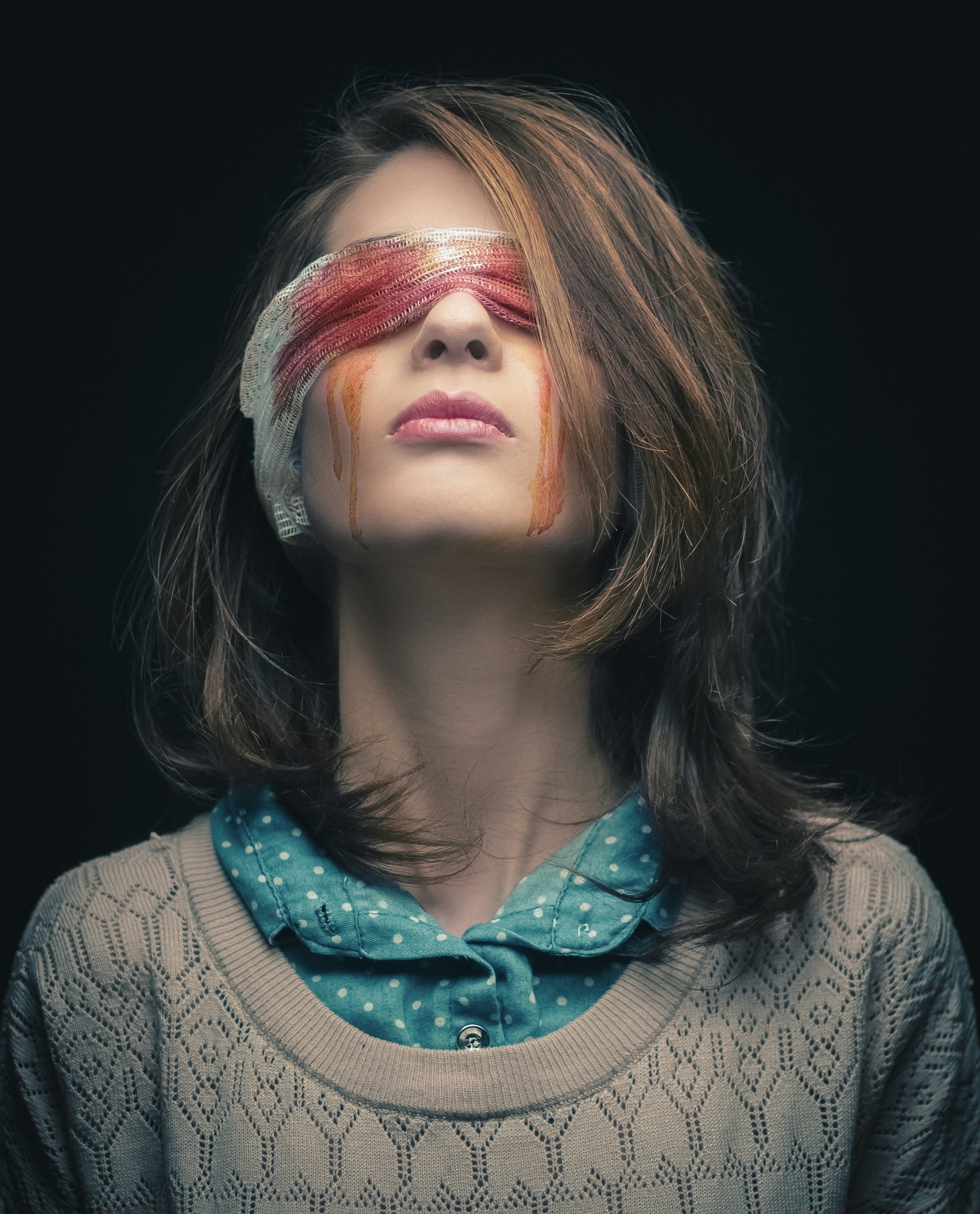 a woman with a blindfold on her face