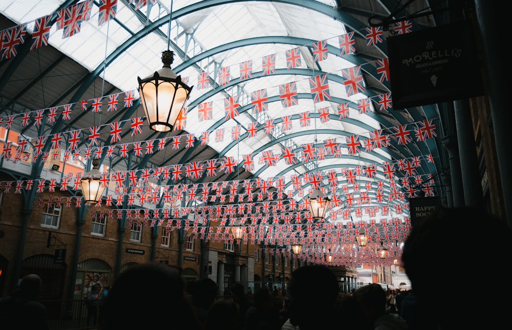 a building with a lot of flags hanging from it's ceiling