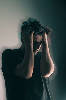 a man holding his head in his hands