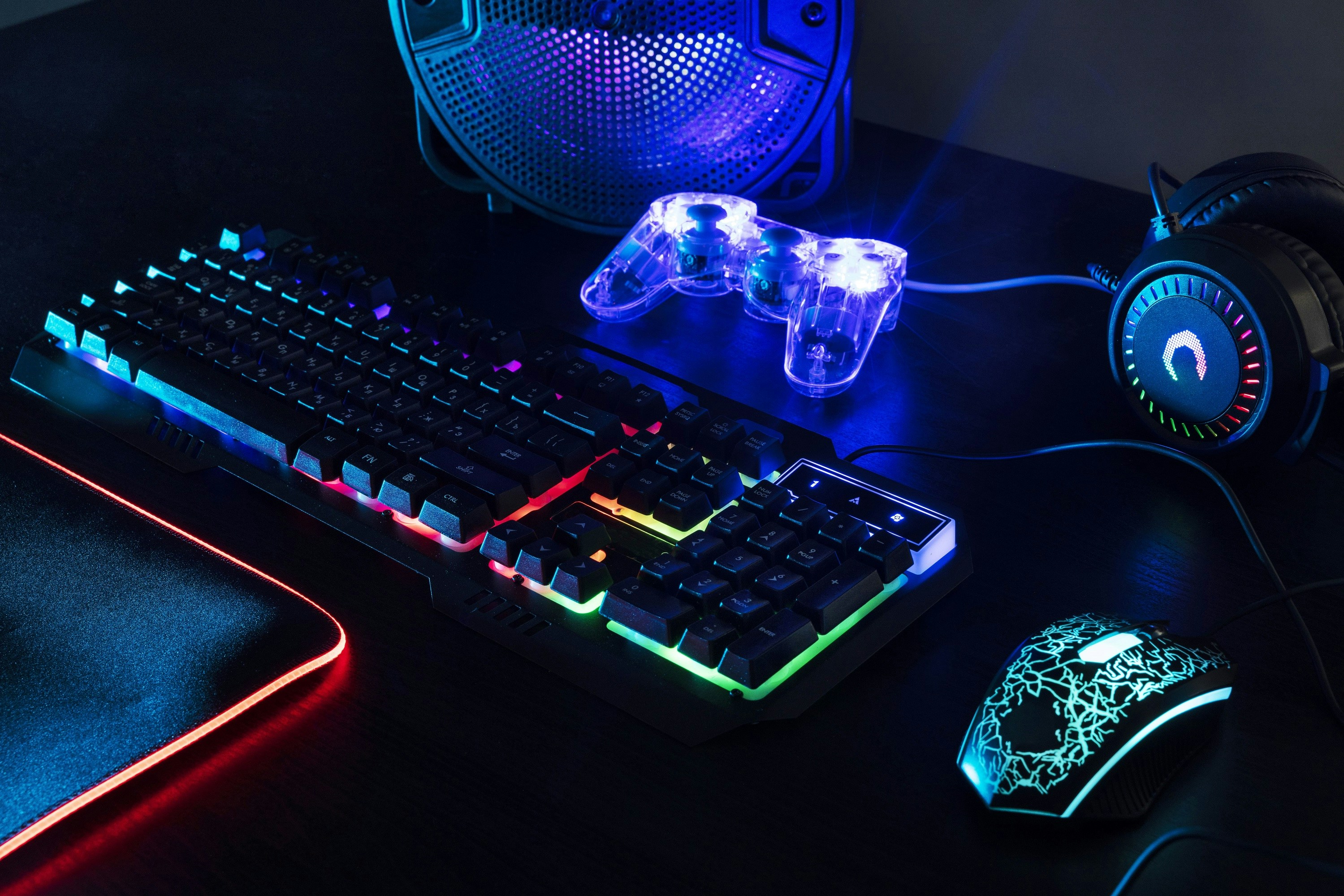 keyboard komputer, mouse, dan headphone di atas meja