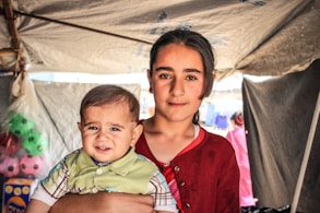 a woman holding a baby in her arms
