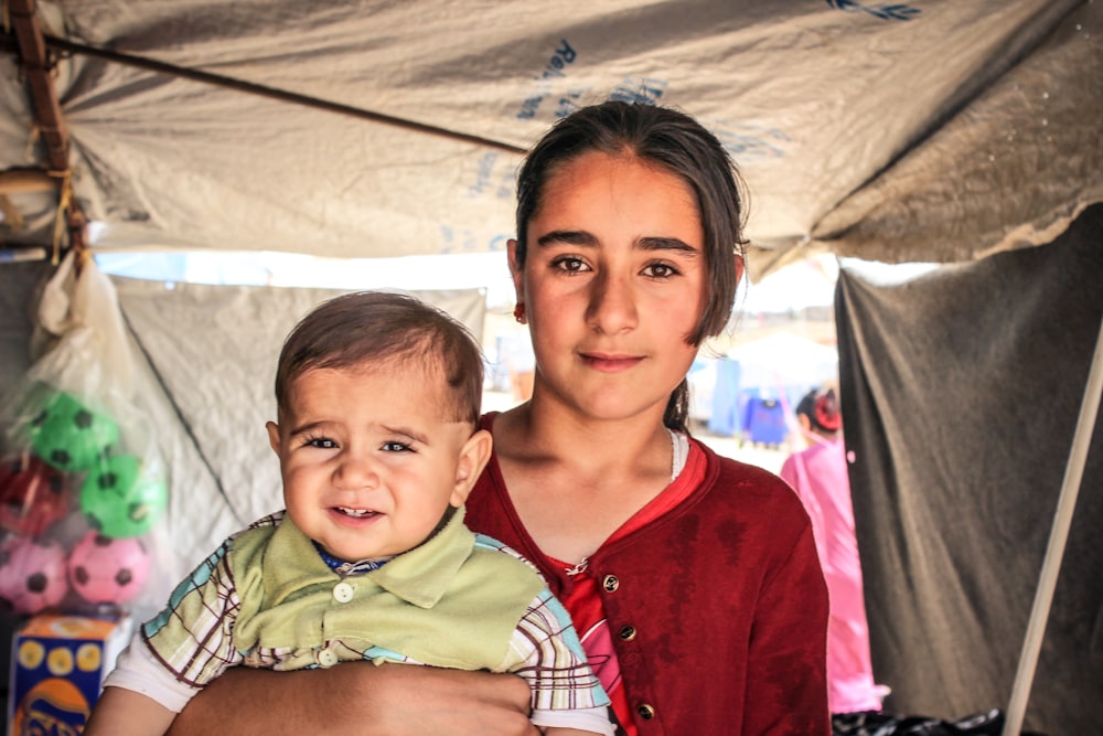 a woman holding a baby in her arms