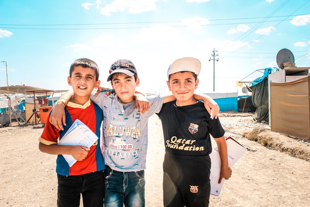 a group of young boys standing next to each other