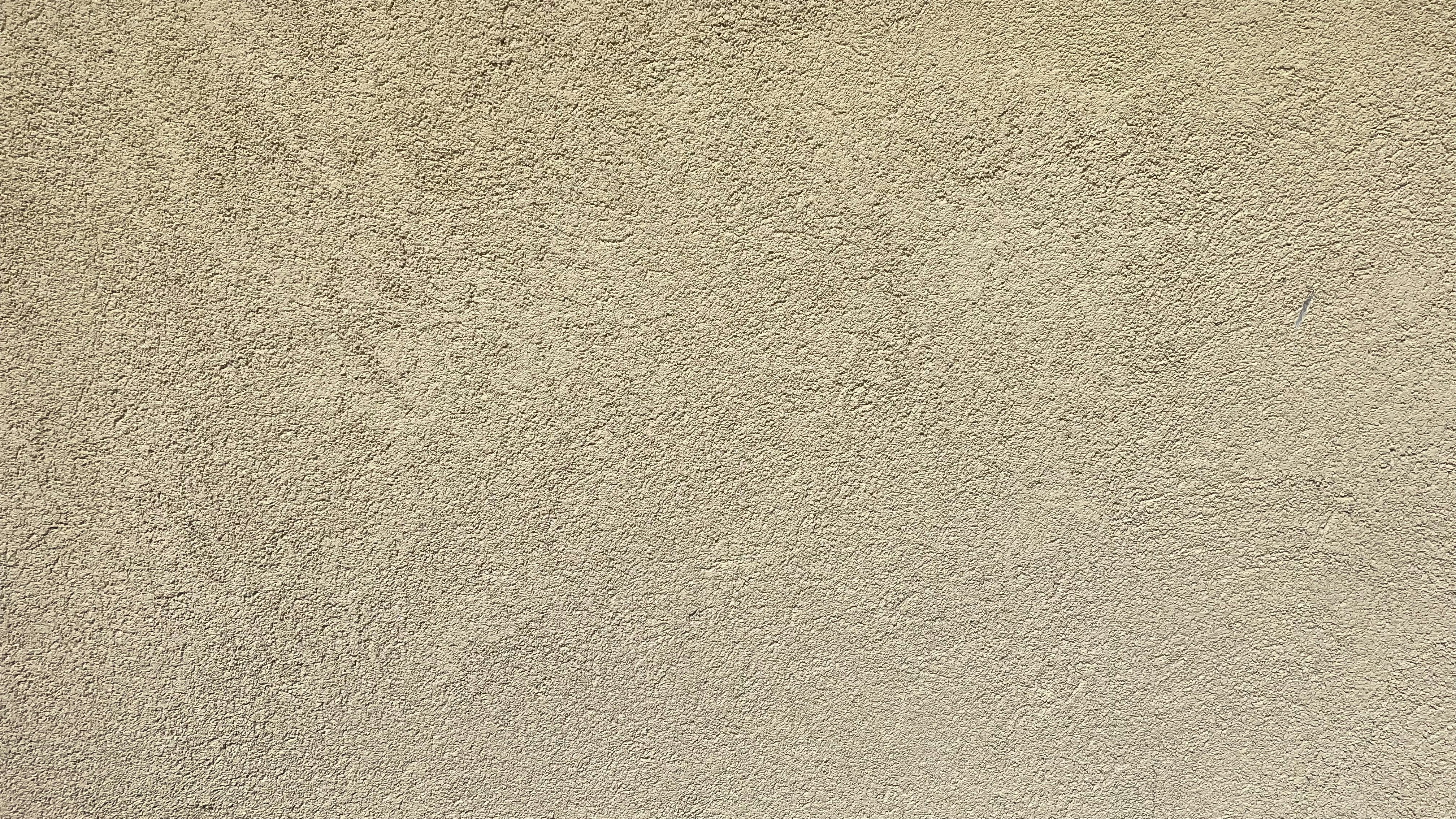Close-up of clean painted stucco exterior wall with warm desert tones