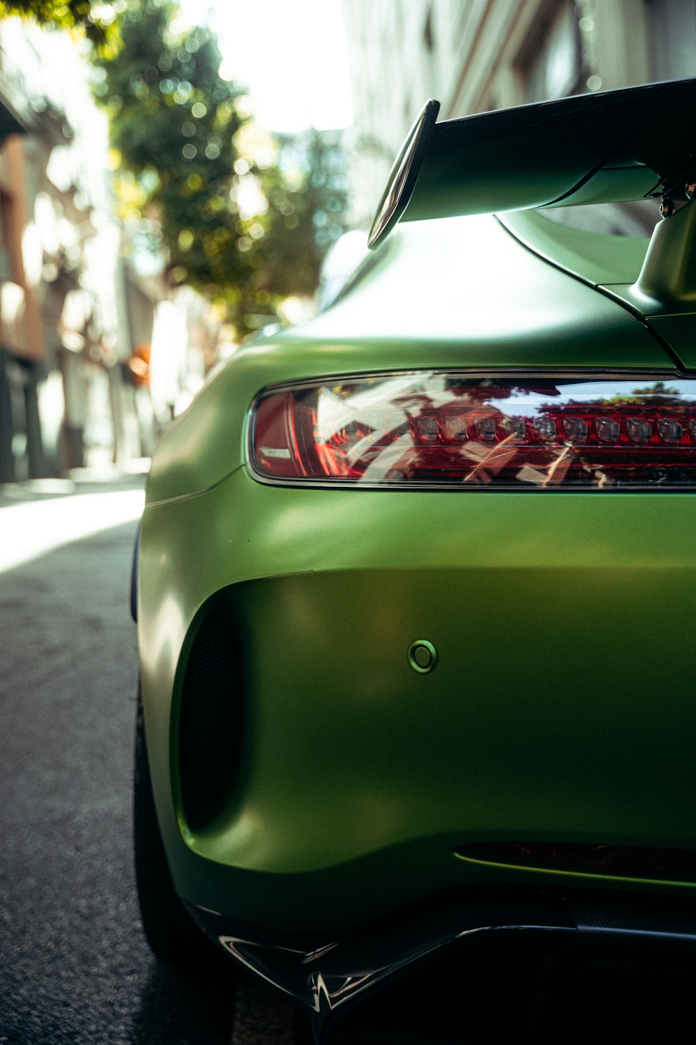 a green sports car parked on the side of the road