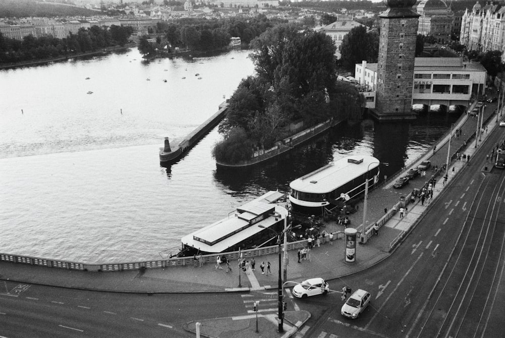 a black and white photo of a river and a bridge