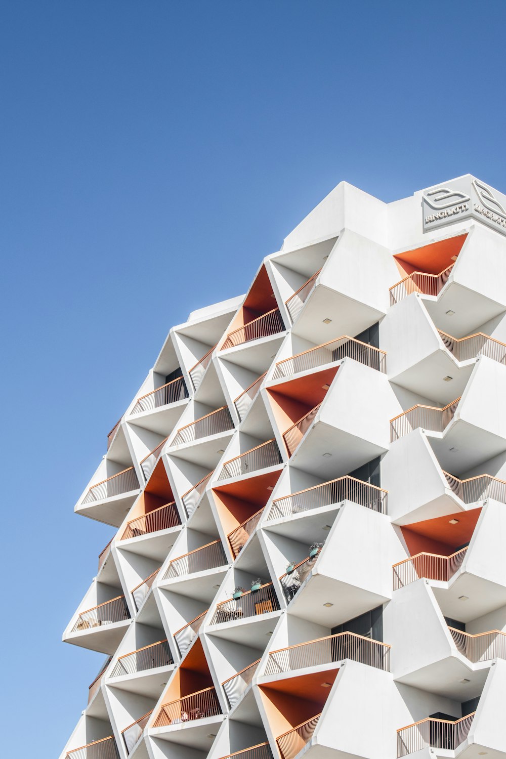 a very tall building with many balconies on it