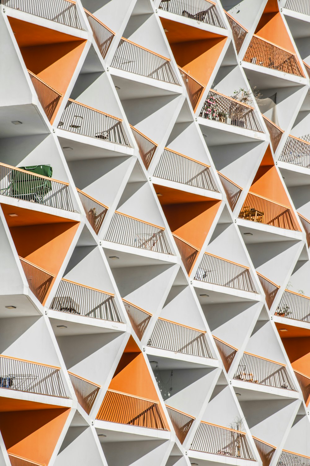 a building with orange and white balconies on it